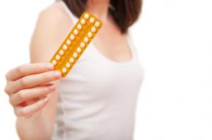 woman-holding-birth-control-pills